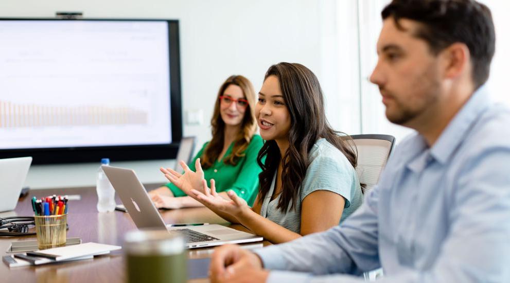 Students having a discussion in a conference room